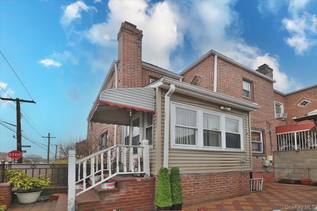 130-71 225th Street Queens, NY 11413 - Photo 23 of 26 a front view of a house with a garden