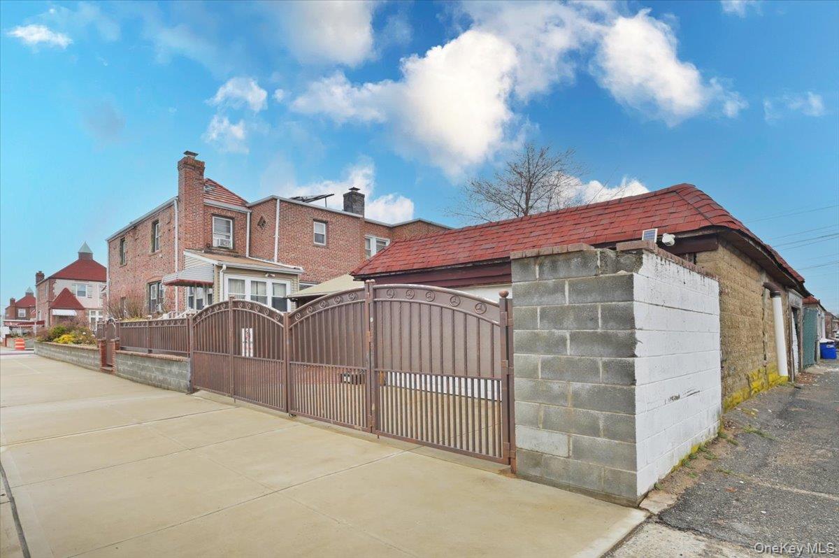130-71 225th Street Queens, NY 11413 - Photo 25 of 26 a view of a white house with iron fence