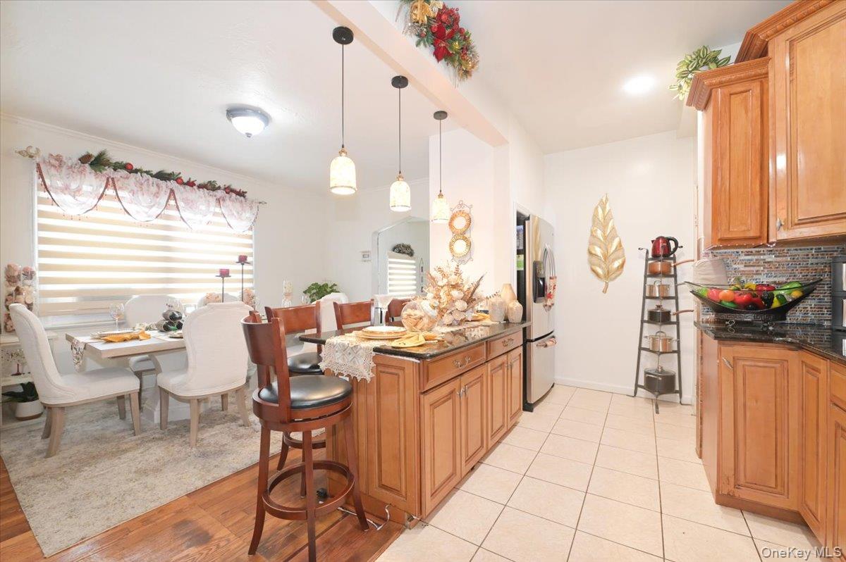 130-71 225th Street Queens, NY 11413 - Photo 10 of 26 a very nice looking dining room with kitchen island furniture a large window and a sink