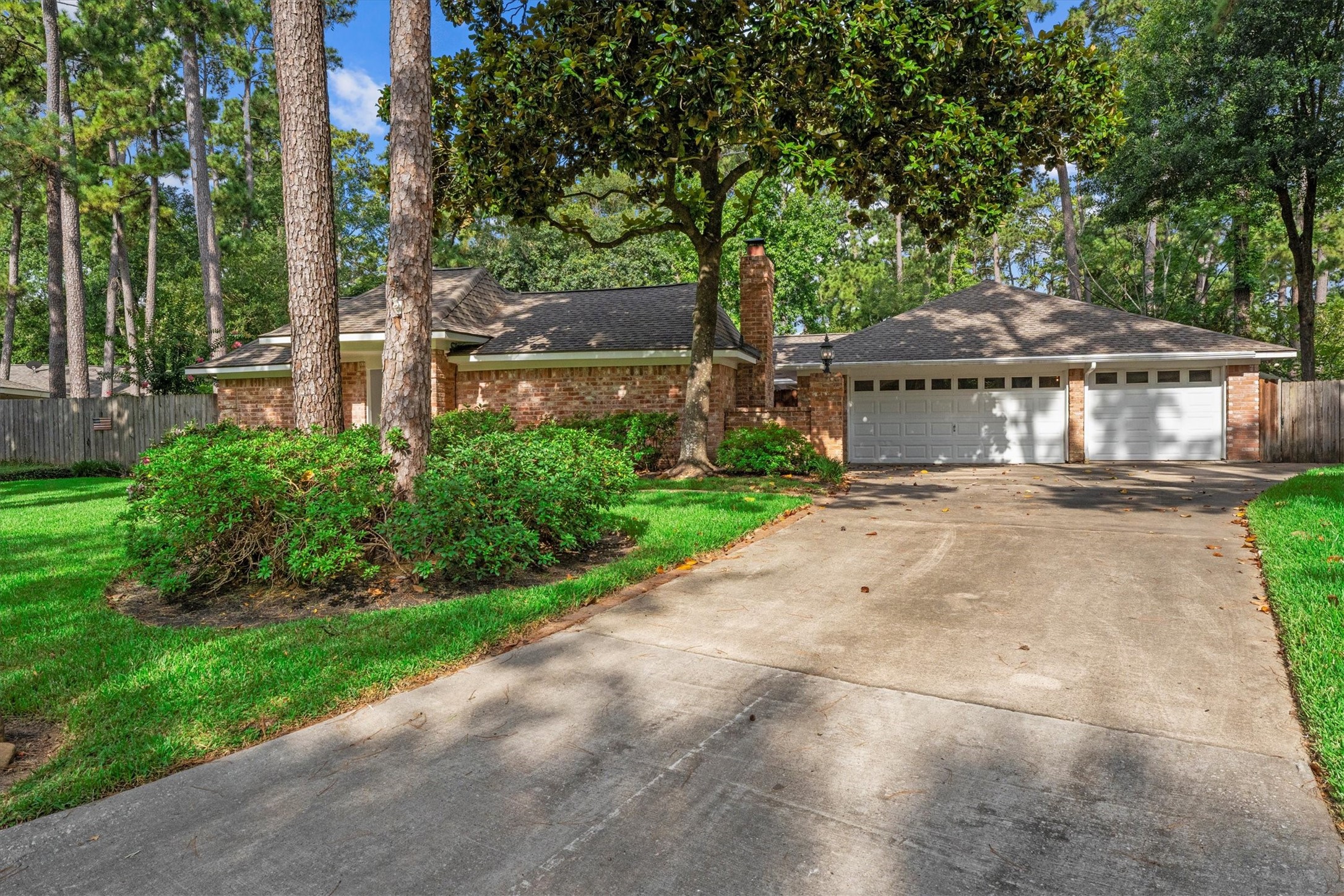 25319 Old Carriage Lane Spring, TX 77373 - Photo 8 of 35 a view of a patio with table and chairs under an umbrella
