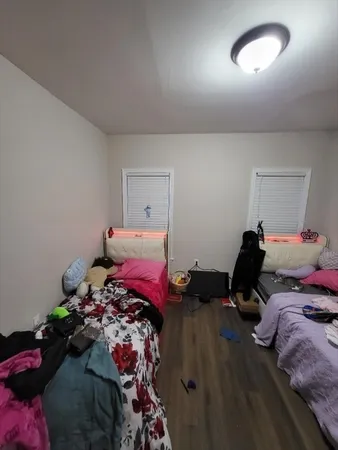 a bedroom with a bed a desk and chair