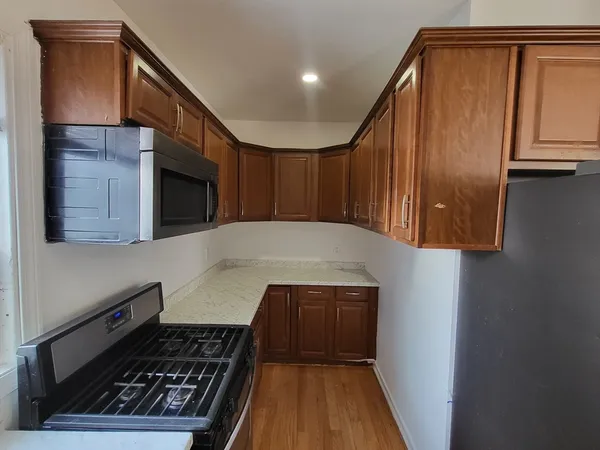 a kitchen with wooden cabinets and a stove top oven
