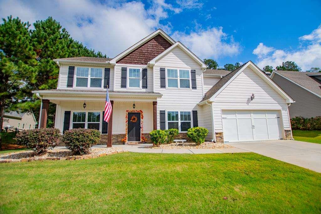 a front view of house with yard and green space