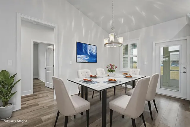 a view of a dining room with furniture window and wooden floor
