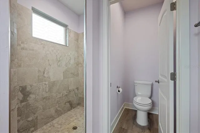 a white toilet sitting next to a bathroom sink