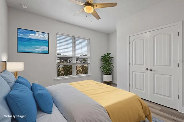 a bedroom with a bed couch and window