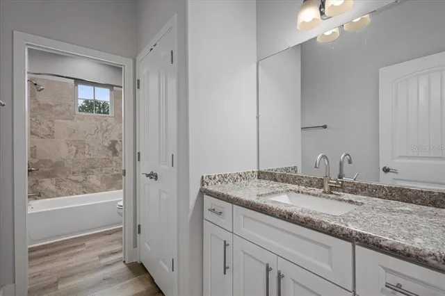 a bathroom with a granite countertop sink a mirror and a