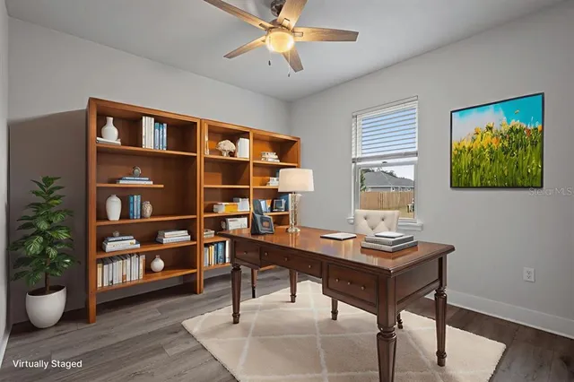 a view of a workspace with furniture and a potted plant