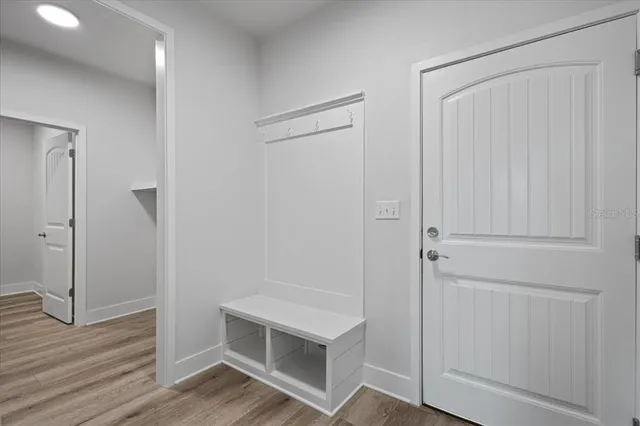 a view of a hallway with wooden floor