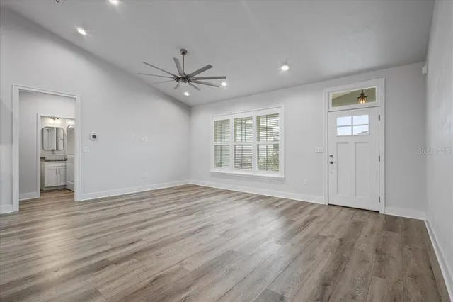 wooden floor in an empty room with a window