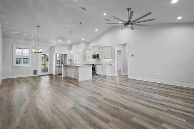 a view of a kitchen with a sink and a refrigerator