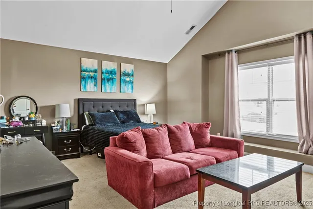 a living room with furniture a fireplace and a window