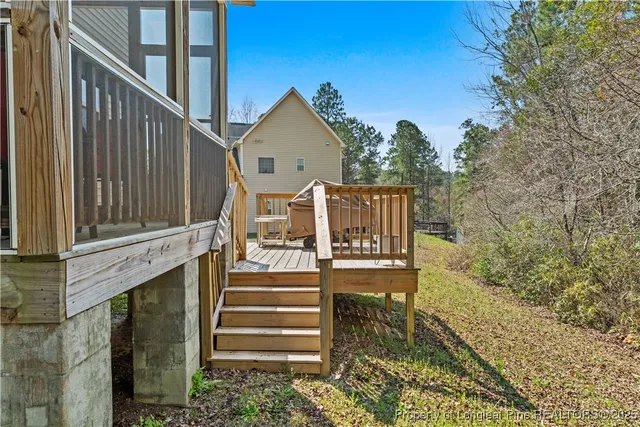 a view of a house with backyard and deck