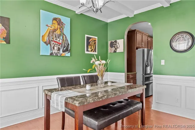 a view of a dining room with furniture and wall paintings