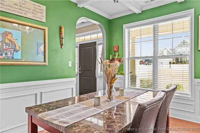 a view of a dining room with furniture and window