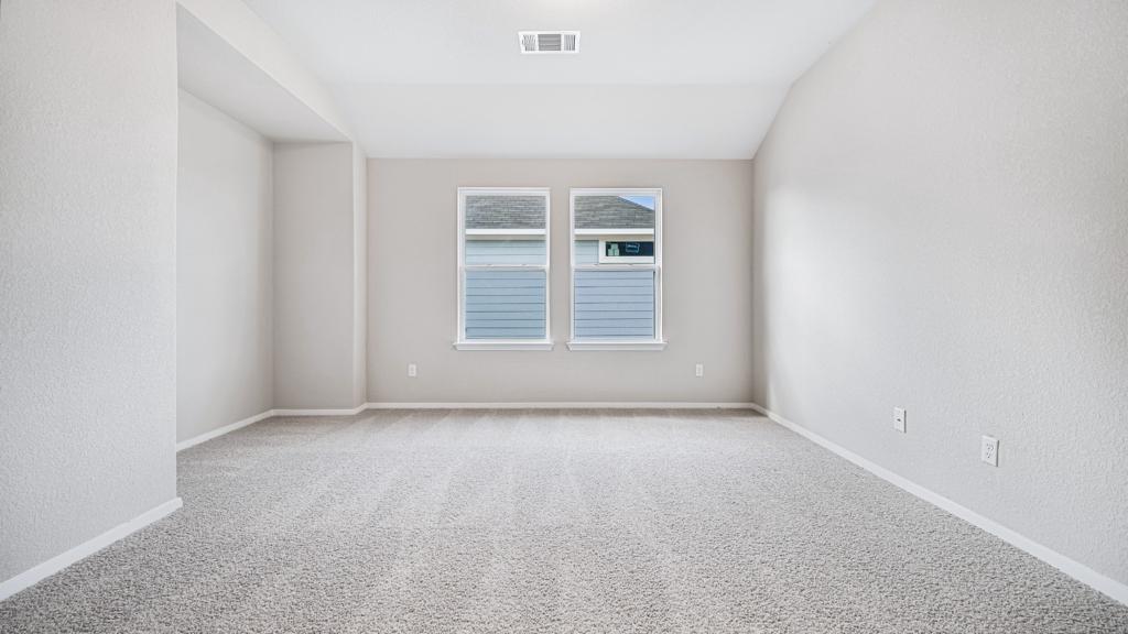 208 Stein Road Georgetown, TX 78626 - Photo 8 of 30 Spare room with carpet flooring, a textured wall, and lofted ceiling