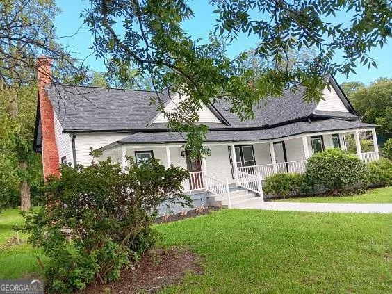 a front view of house with yard and green space