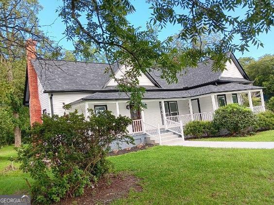 a front view of house with yard and green space