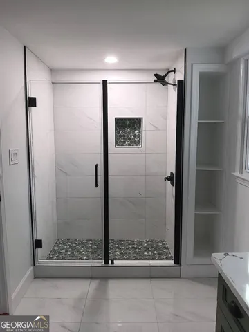 a bathroom with a glass shower door