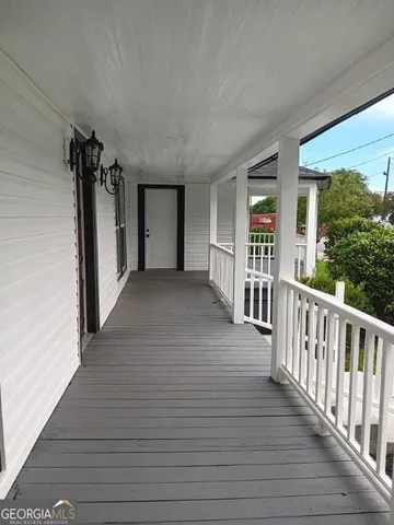 a view of a porch with wooden floor and stairs