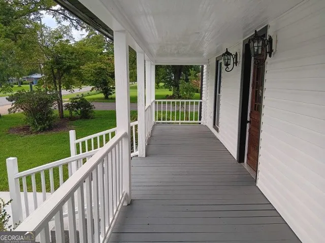 a view of a balcony with wooden floor