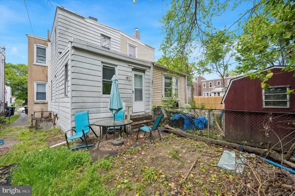 a backyard of a house with table and chairs