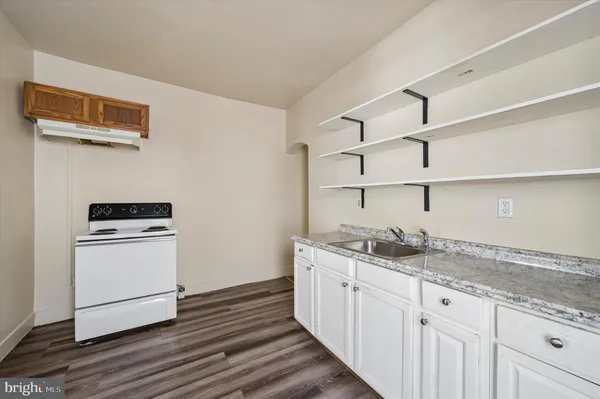 a kitchen with stainless steel appliances granite countertop a sink stove and cabinets