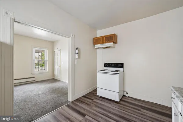 a kitchen with a refrigerator and a stove