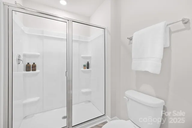 a bathroom with a shower a toilet and a sink