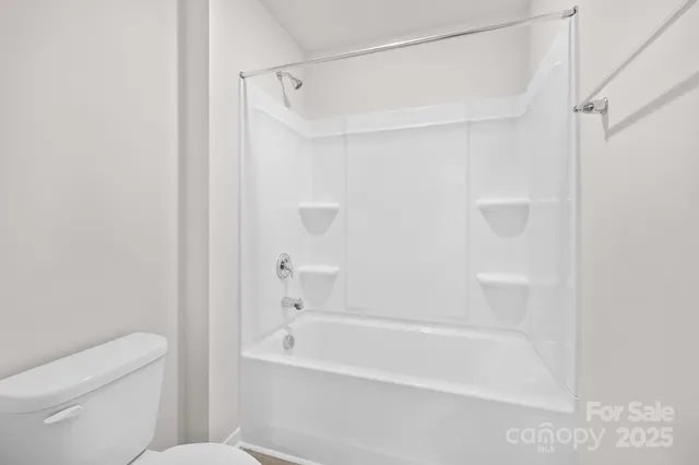 a bathroom with a shower and a toilet