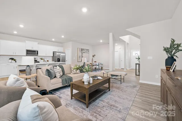 a living room with furniture kitchen view and a couch