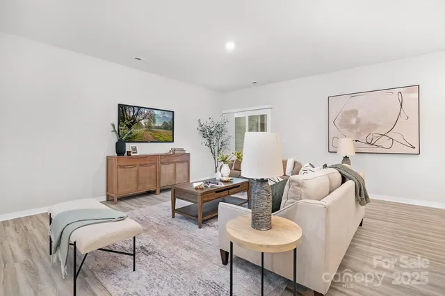 a living room with furniture and a wooden floor