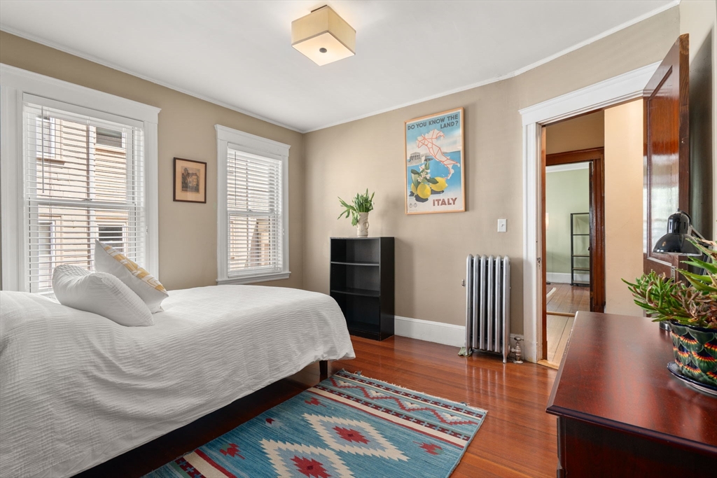 45 Springfield Street, Unit 1 Belmont, MA 02478 - Photo 14 of 27 a bedroom with a bed and wooden floor