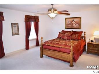 166 Heyer Road Nazareth, PA 18064 - Photo 11 of 15 a bedroom with a bed and painting on the wall