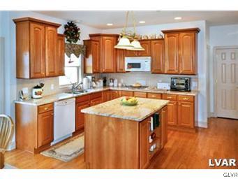 166 Heyer Road Nazareth, PA 18064 - Photo 5 of 15 a kitchen with a sink stove and cabinets