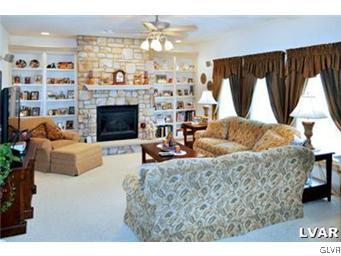 166 Heyer Road Nazareth, PA 18064 - Photo 7 of 15 a living room with furniture a fireplace and a large window