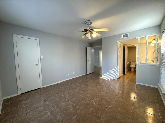a bathroom with a granite countertop double vanity sink a mirror and a toilet