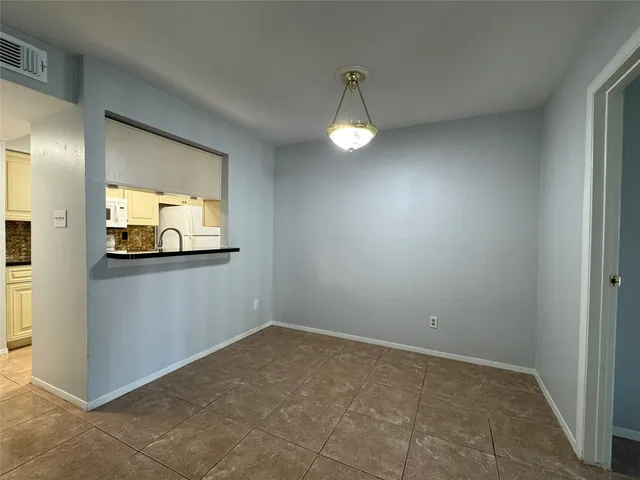 a kitchen with stainless steel appliances granite countertop a sink and a stove
