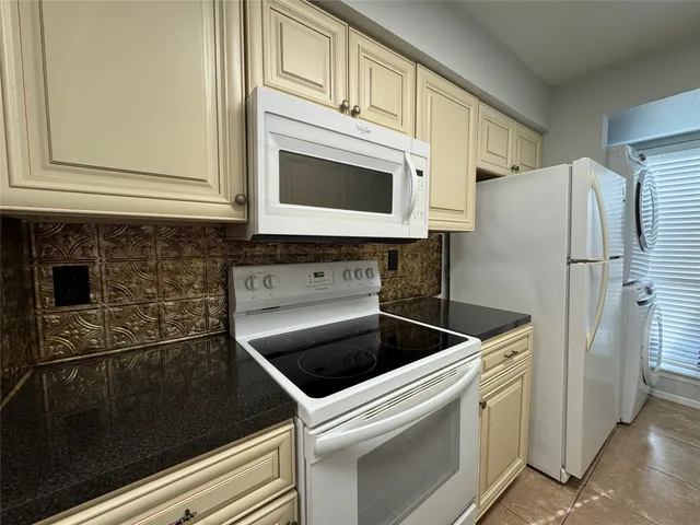 a kitchen with stainless steel appliances granite countertop a sink and a stove