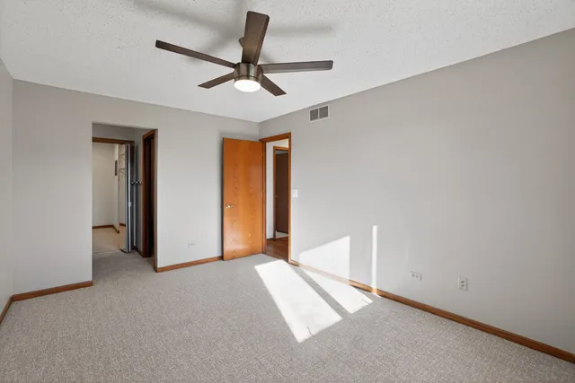 a view of a livingroom with a ceiling fan and window