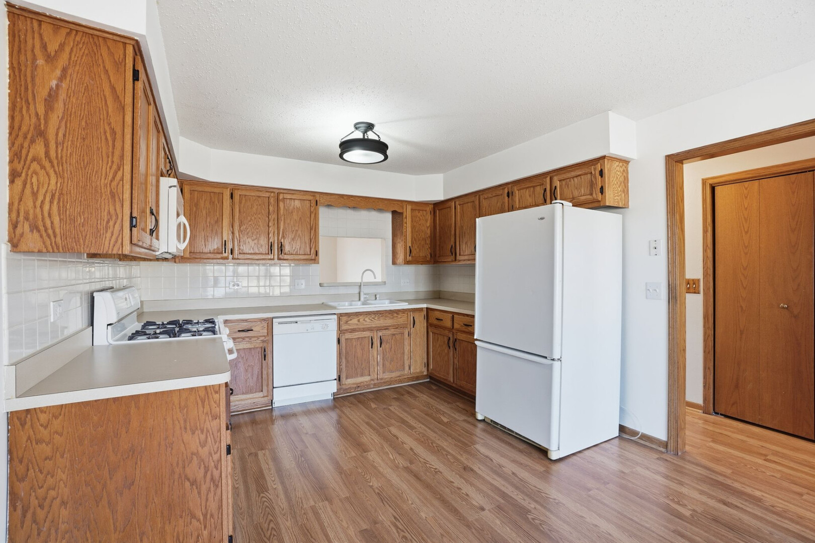 102 Wyndstone Drive Elwood, IL 60421 - Photo 8 of 31 a kitchen with stainless steel appliances granite countertop a refrigerator sink and cabinets