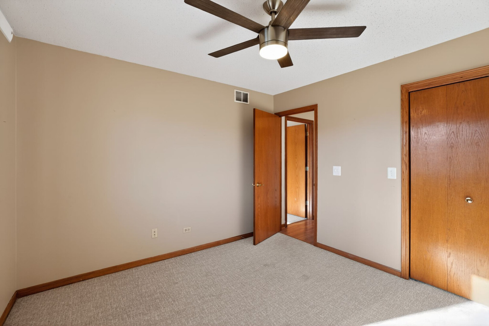 102 Wyndstone Drive Elwood, IL 60421 - Photo 10 of 31 an empty room with a ceiling fan and a window