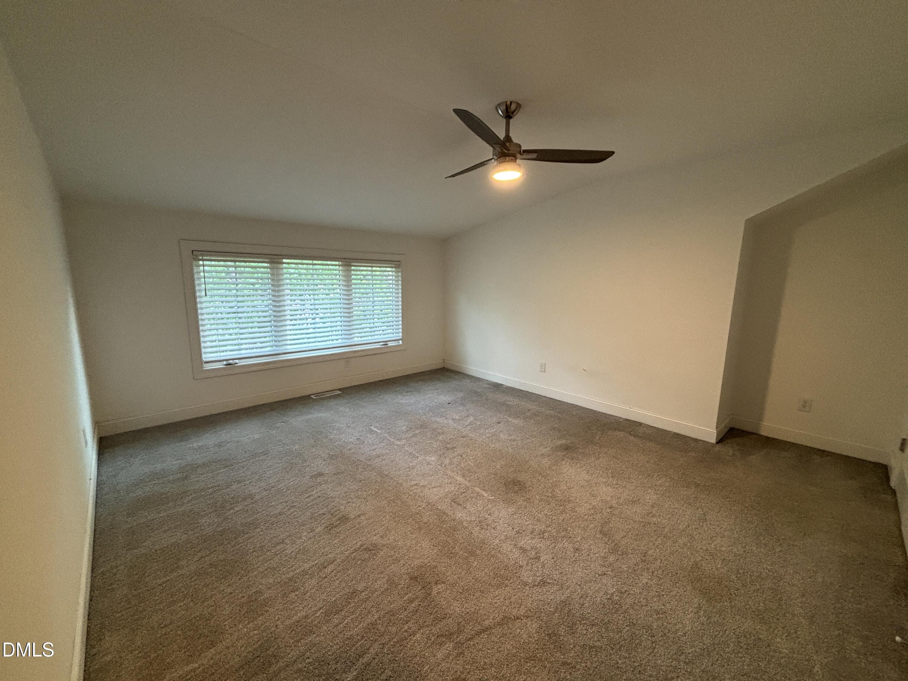 5710 Parker Pnes Court Raleigh, NC 27609 - Photo 69 of 78 an empty room with a window and a fan