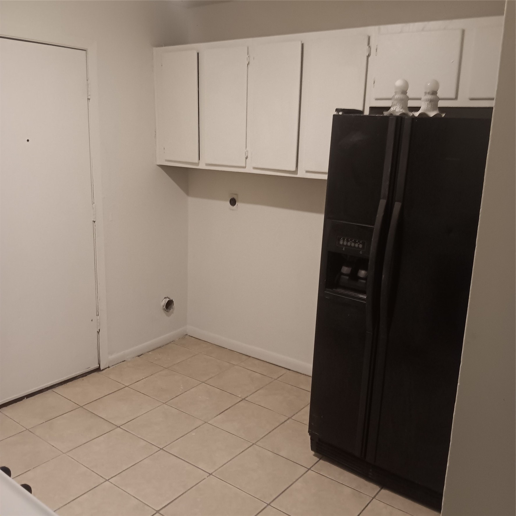 521 Ferguson Street, Unit B1 Humble, TX 77338 - Photo 6 of 7 a view of a refrigerator and cabinets