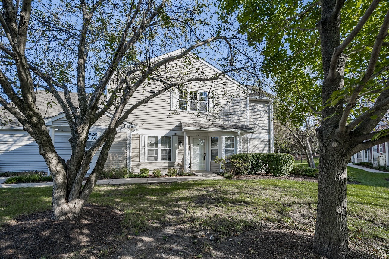 2827 Rutland Circle, Unit 101 Naperville, IL 60564 - Photo 1 of 25 a front view of a house with garden
