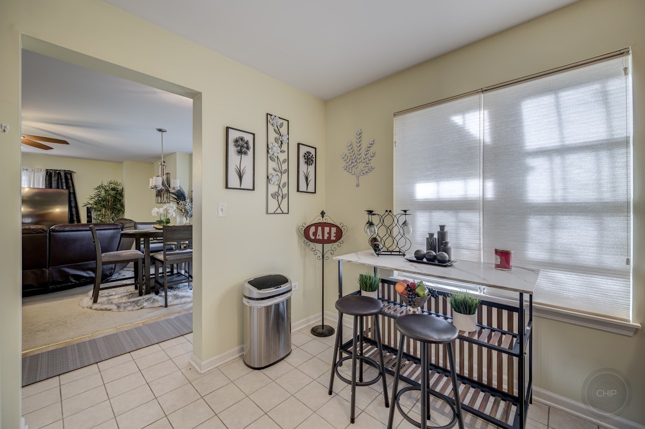 2827 Rutland Circle, Unit 101 Naperville, IL 60564 - Photo 13 of 25 a dining room with furniture and a window