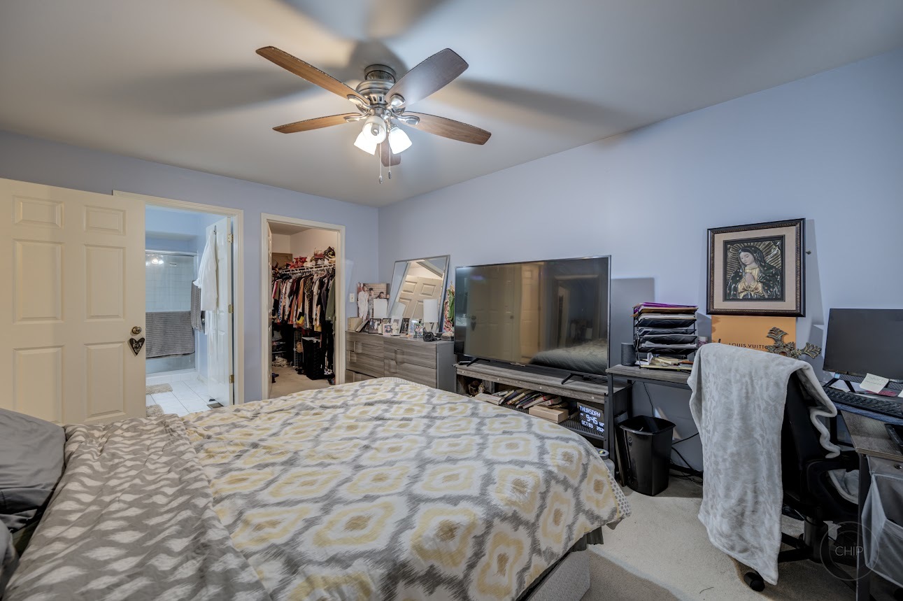 2827 Rutland Circle, Unit 101 Naperville, IL 60564 - Photo 15 of 25 a bedroom with a bed and a flat screen tv