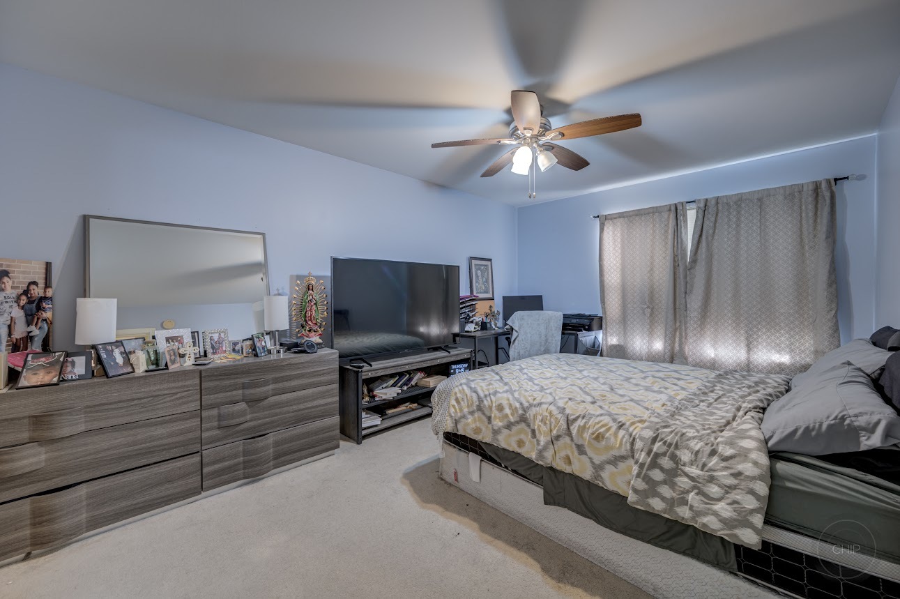 2827 Rutland Circle, Unit 101 Naperville, IL 60564 - Photo 16 of 25 a bedroom with a bed and a flat screen tv