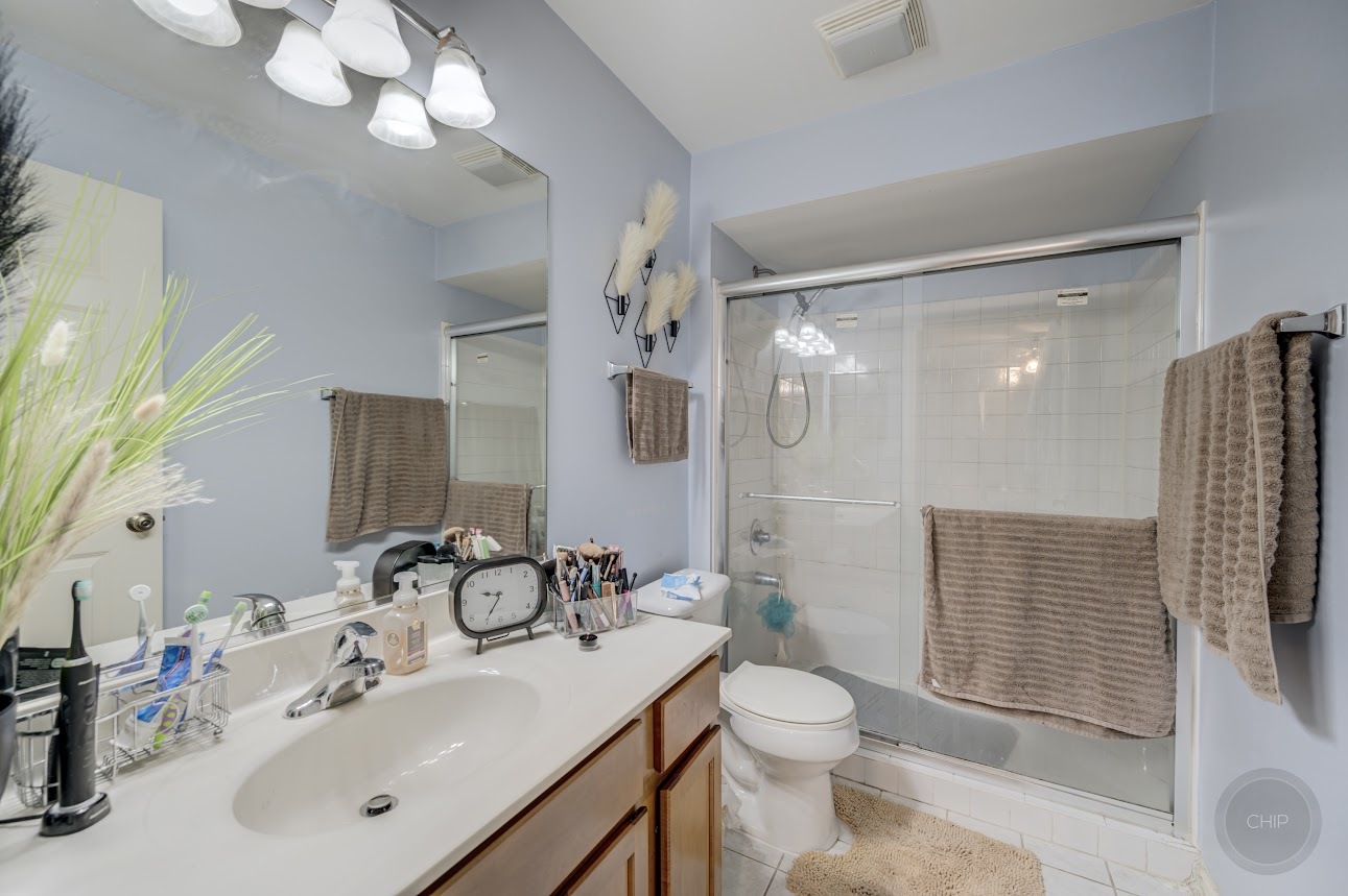 2827 Rutland Circle, Unit 101 Naperville, IL 60564 - Photo 17 of 25 a bathroom with a sink a toilet and shower