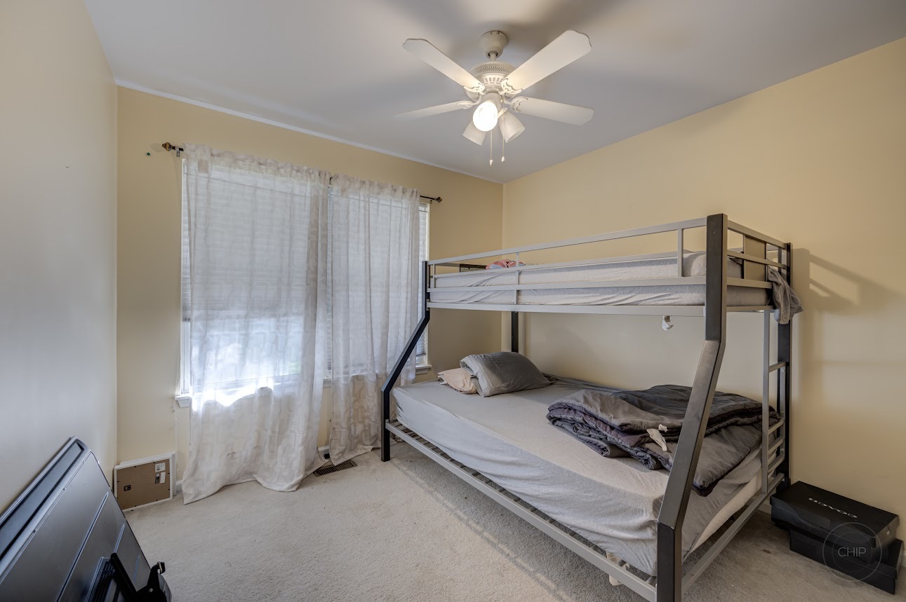 2827 Rutland Circle, Unit 101 Naperville, IL 60564 - Photo 18 of 25 a bedroom with a bed and a window